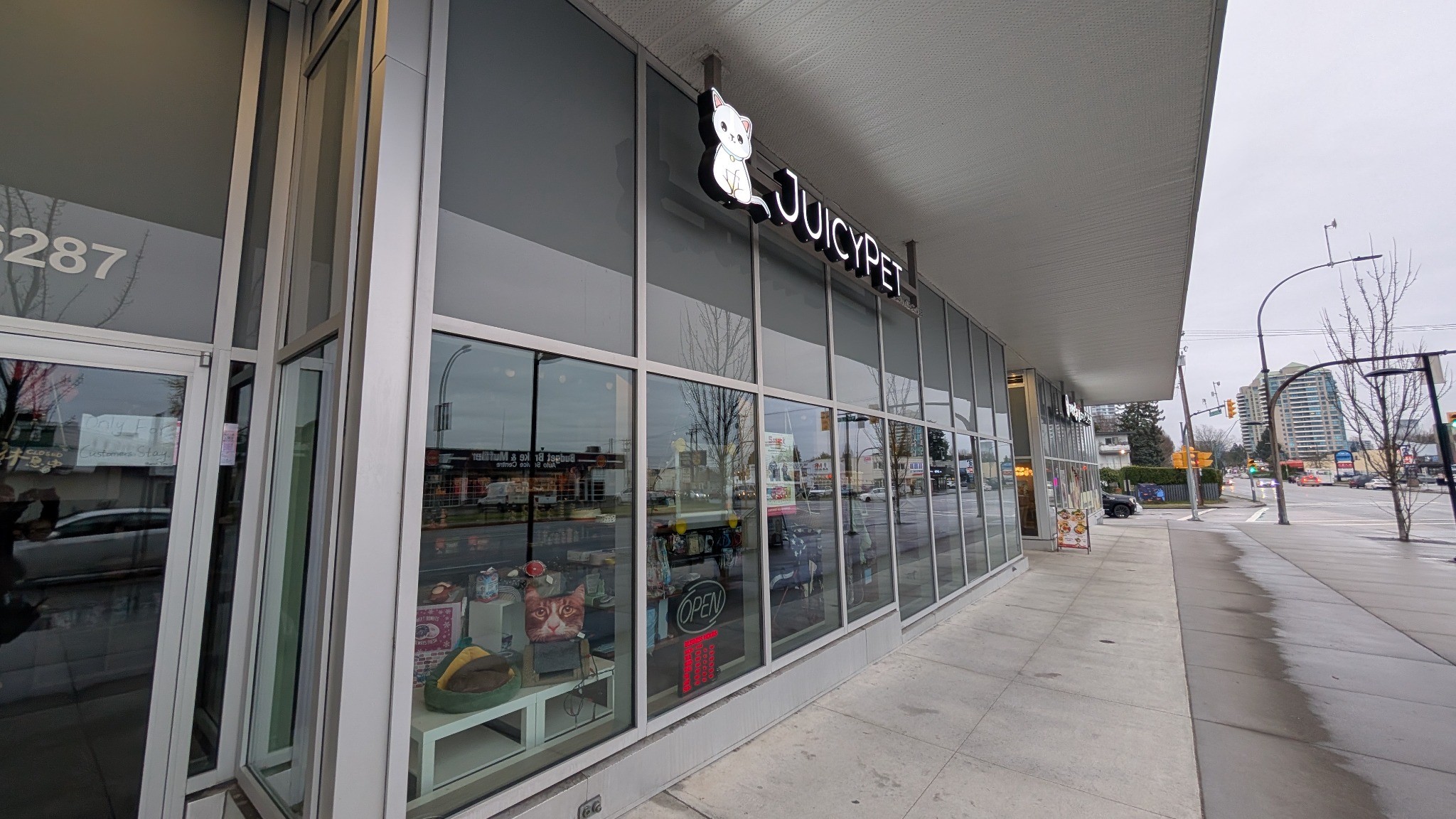 Long glass storefront along a commercial sidewalk